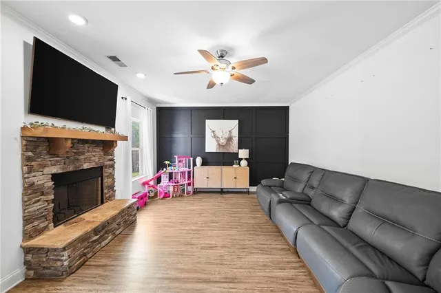 a living room with furniture fireplace and flat screen tv
