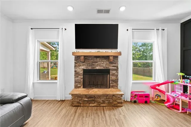 a living room with furniture and a fireplace