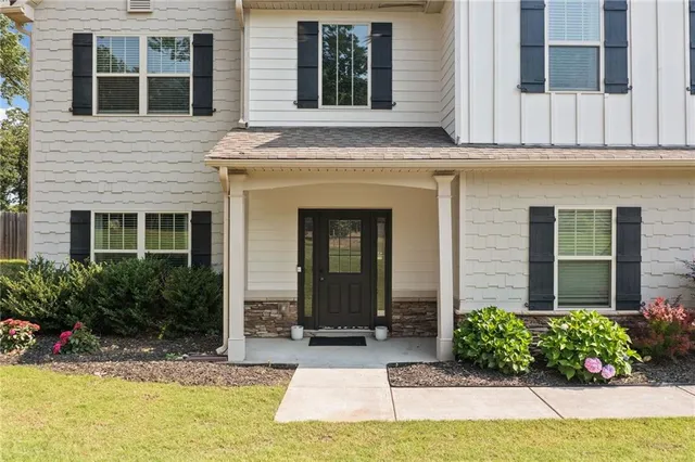 a front view of a house with garden