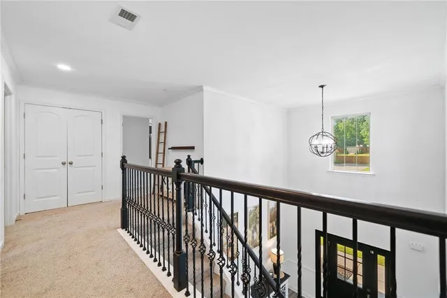 a bedroom with a white bed and a large window