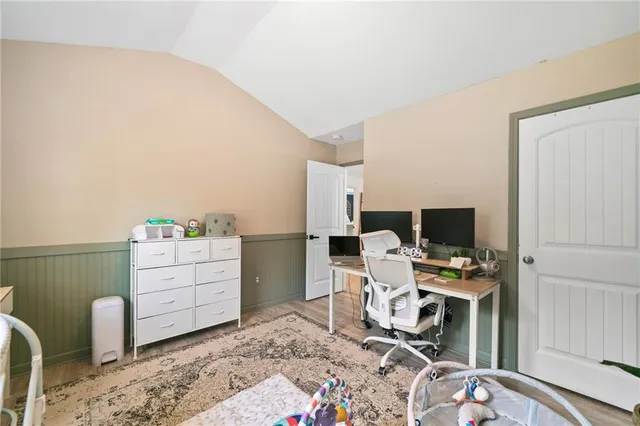 a bed room with a bed and a television