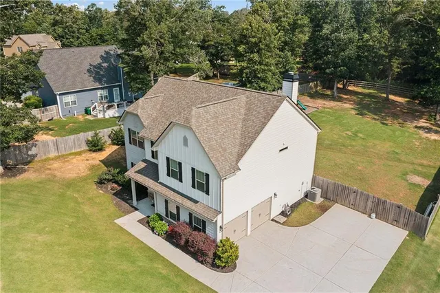 an aerial view of a house with swimming pool