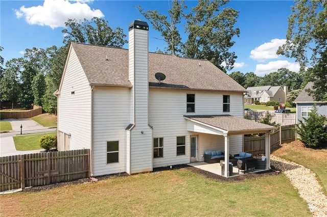 a view of a house with wooden walls and floor to ceiling window