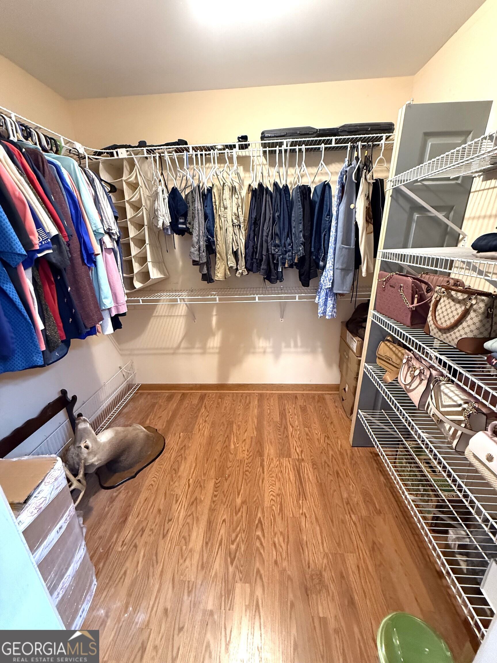 725 Musgrove Road Griffin, GA 30223 - Photo 27 of 52 a view of walk in closet with clothes and shoes