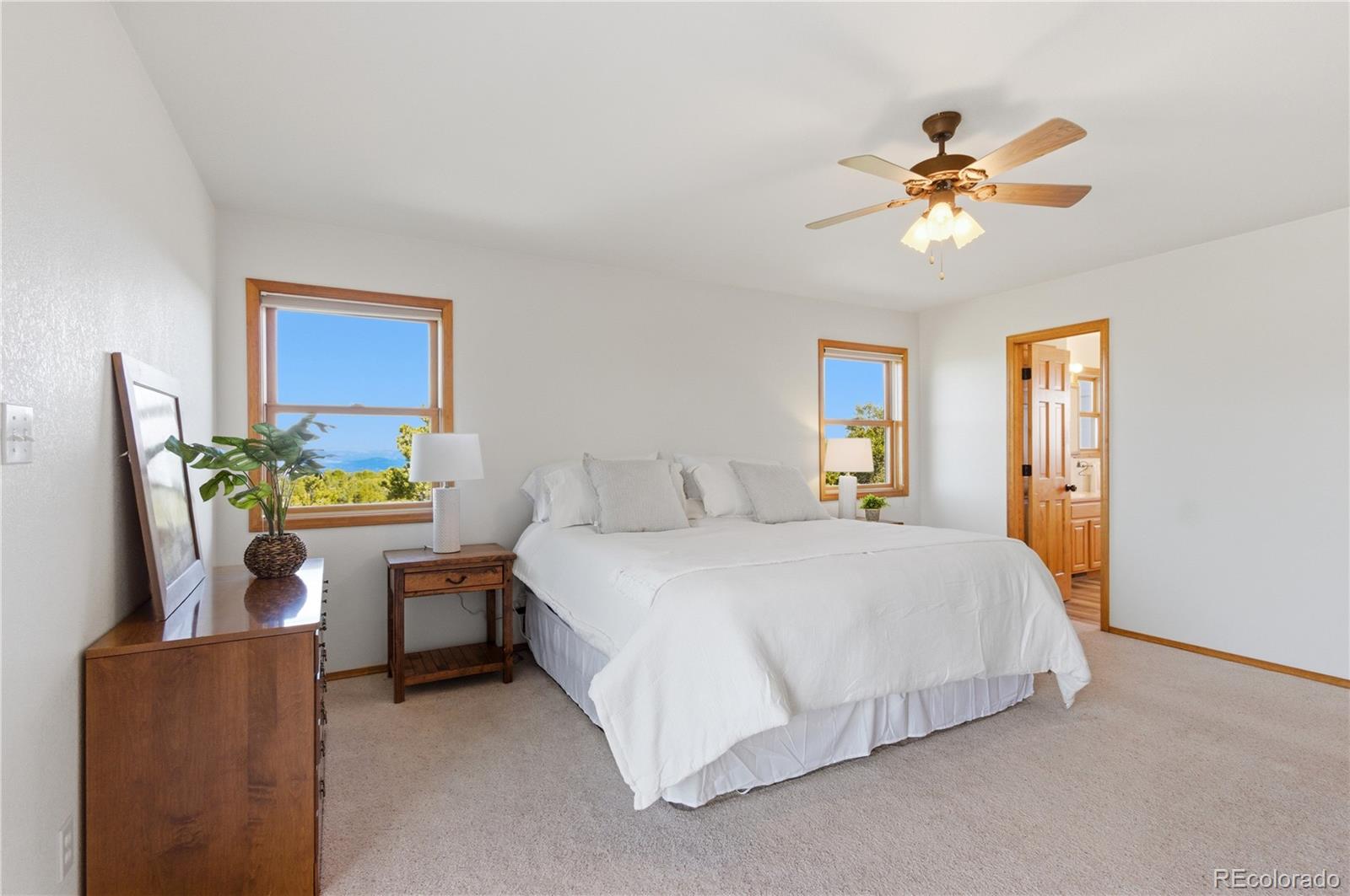 90 Riggs Road Westcliffe, CO 81252 - Photo 13 of 35 a bedroom with a bed and a chandelier