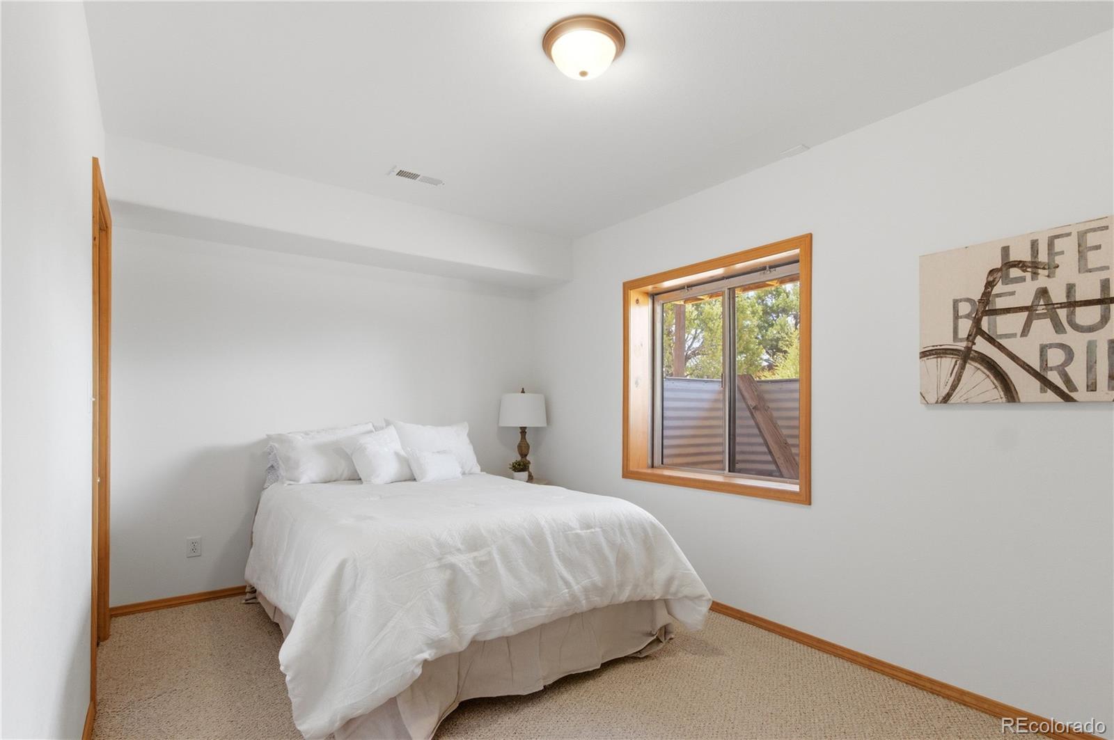90 Riggs Road Westcliffe, CO 81252 - Photo 16 of 35 a bedroom with a bed and a window