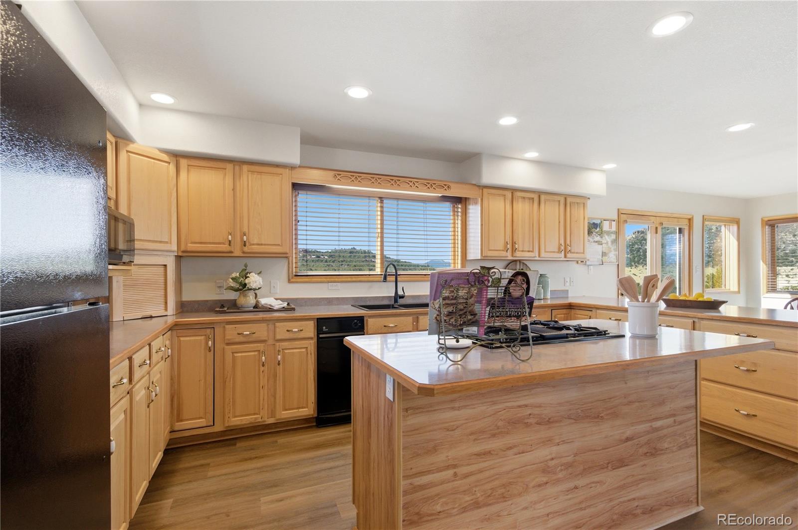 90 Riggs Road Westcliffe, CO 81252 - Photo 6 of 35 a kitchen with kitchen island granite countertop a sink cabinets and counter space