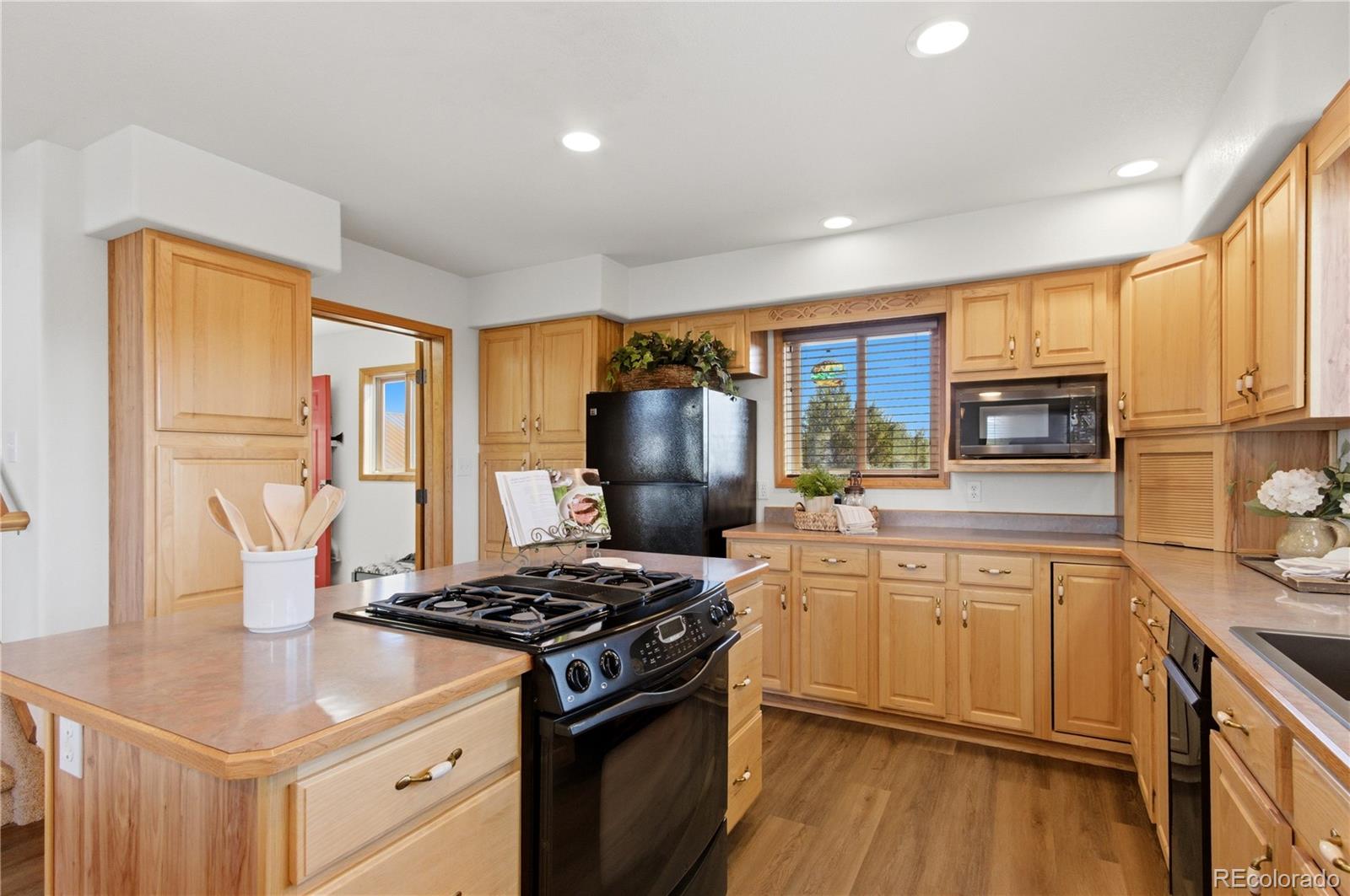 90 Riggs Road Westcliffe, CO 81252 - Photo 7 of 35 a kitchen with a stove a sink and a refrigerator