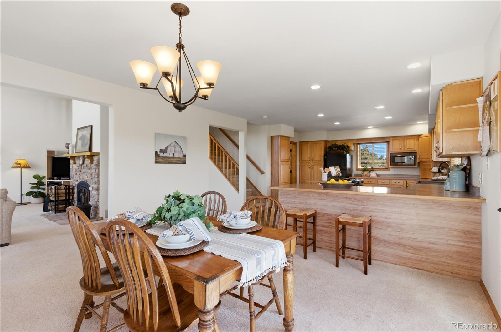 90 Riggs Road Westcliffe, CO 81252 - Photo 9 of 35 a view of a dining room and livingroom with furniture wooden floor a chandelier