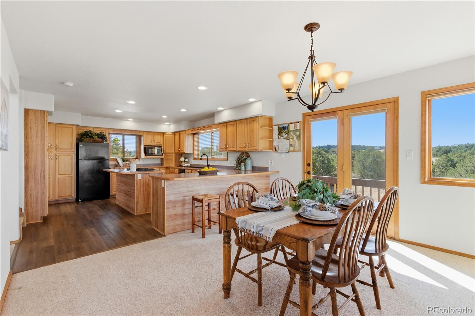 90 Riggs Road Westcliffe, CO 81252 - Photo 10 of 35 a kitchen with a dining table chairs stainless steel appliances and cabinets