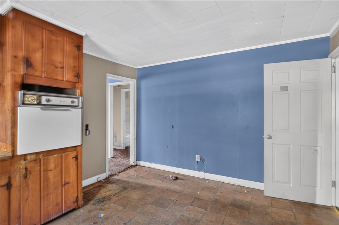 676 Marcengill Road Westminster, SC 29693 - Photo 11 of 32 Tiled flooring and wood cabinetry define this functional kitchen space.