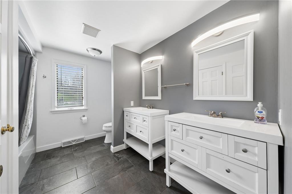 153 Oakwood Road Canonsburg, PA 15317 - Photo 14 of 26 a bathroom with a double vanity sink and mirror