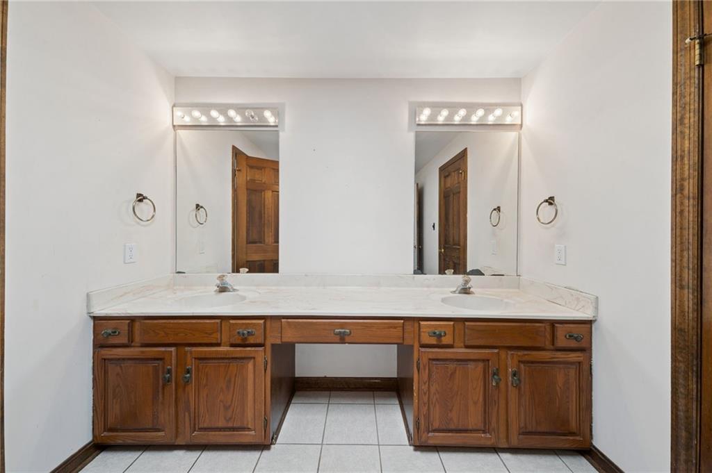 153 Oakwood Road Canonsburg, PA 15317 - Photo 17 of 26 a bathroom with a granite countertop double vanity sink and a mirror
