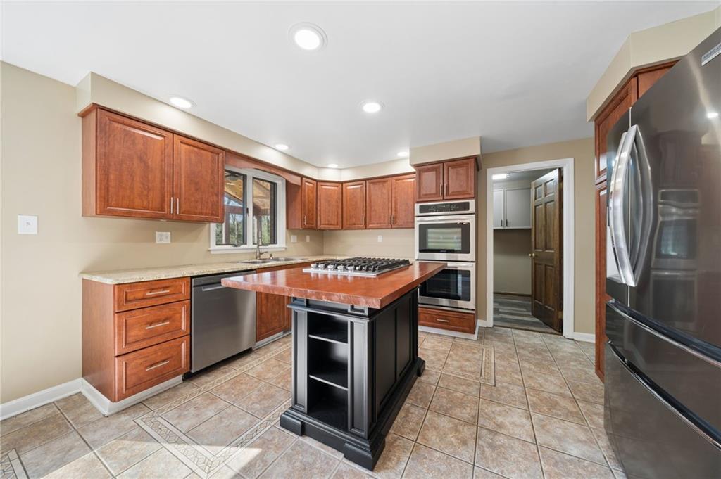 153 Oakwood Road Canonsburg, PA 15317 - Photo 10 of 26 a kitchen with stainless steel appliances granite countertop a refrigerator and a stove top oven