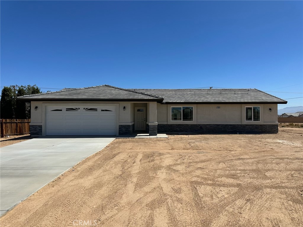 13155 Lakota Road Apple Valley, CA 92308 - Photo 1 of 1 a front view of a house with a yard