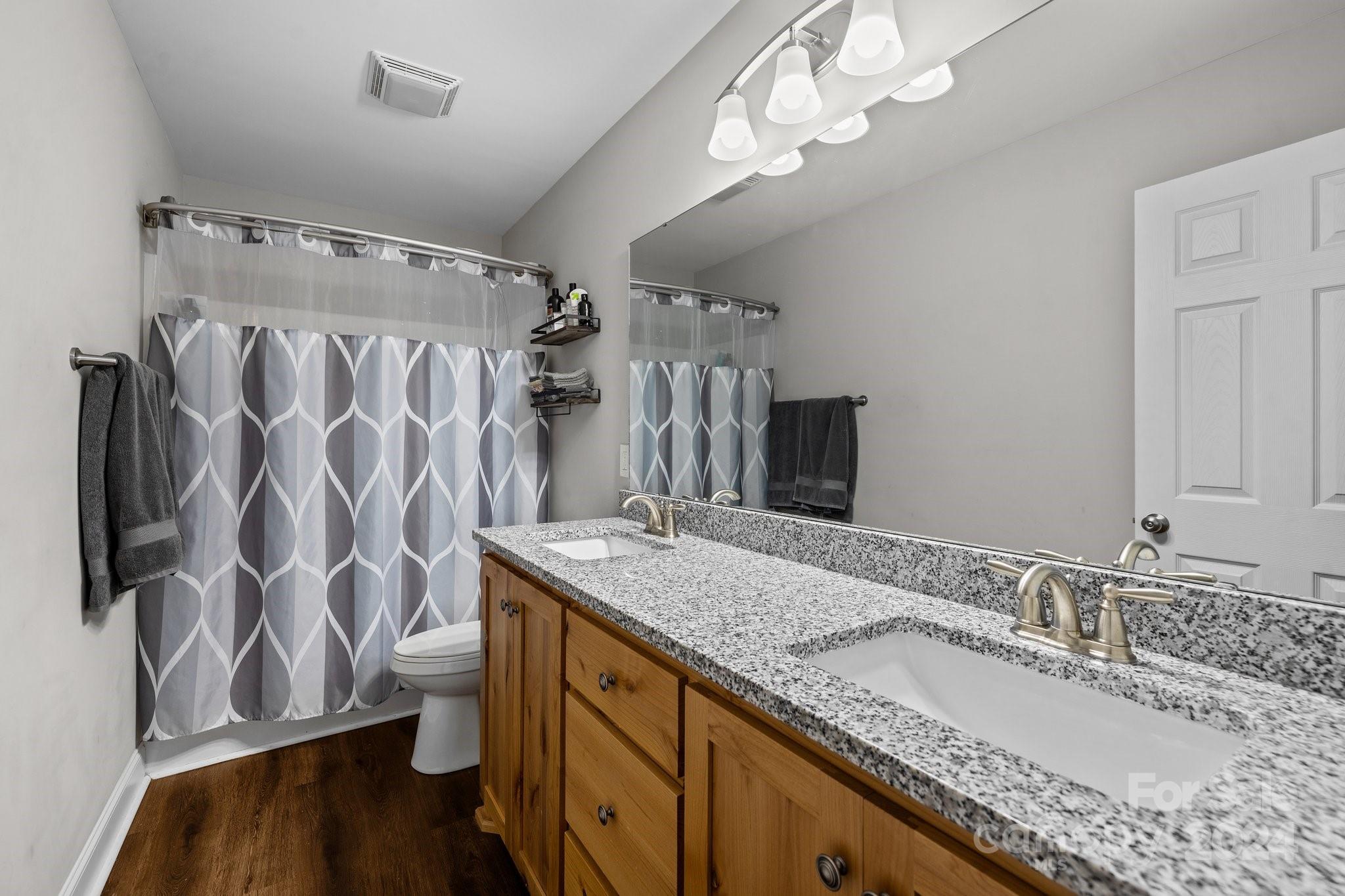 1455 Lawrence Road Clover, SC 29710 - Photo 15 of 35 a bathroom with a granite countertop sink a mirror and shower