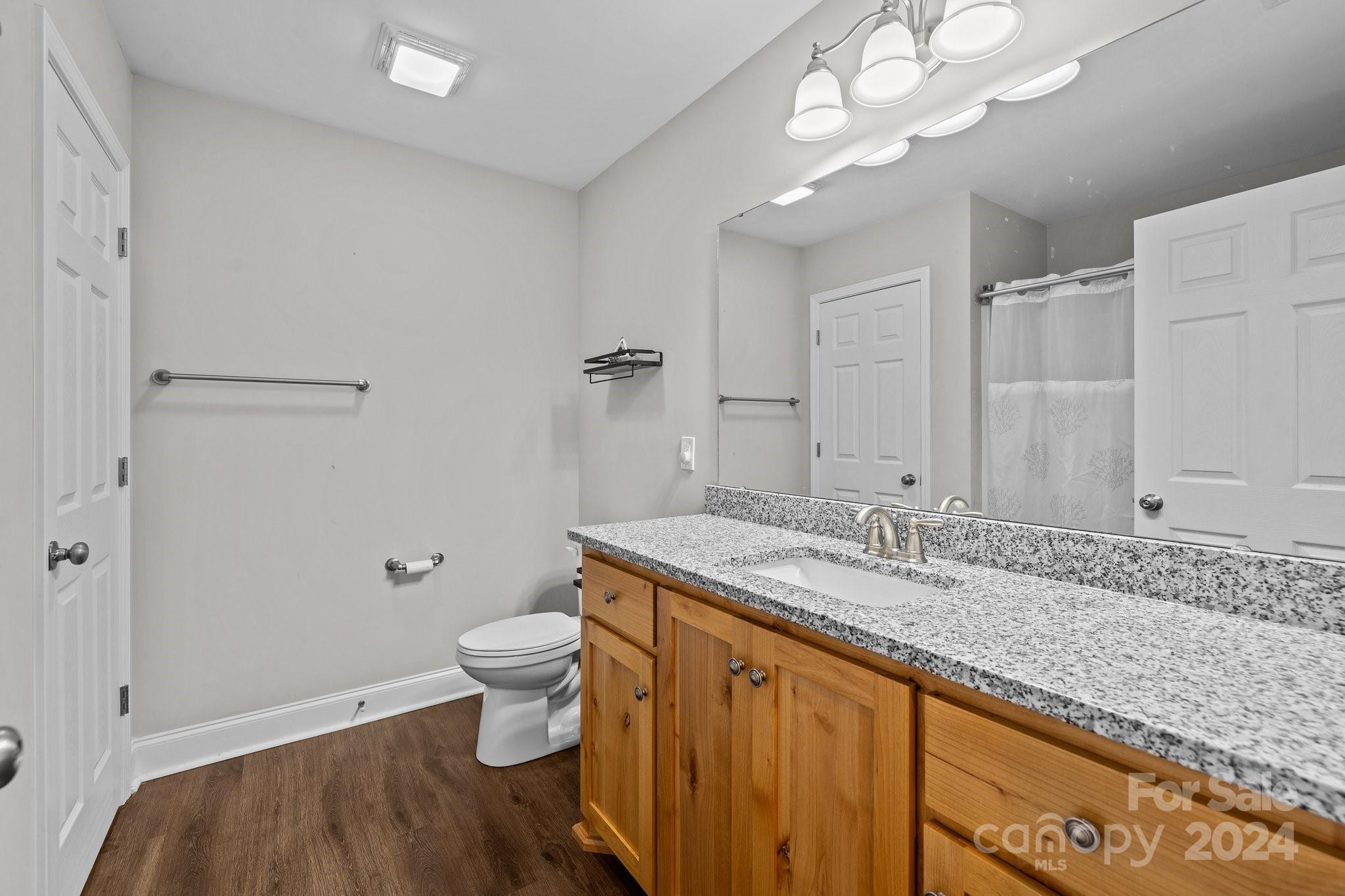 1455 Lawrence Road Clover, SC 29710 - Photo 18 of 35 a bathroom with a granite countertop sink a toilet and shower