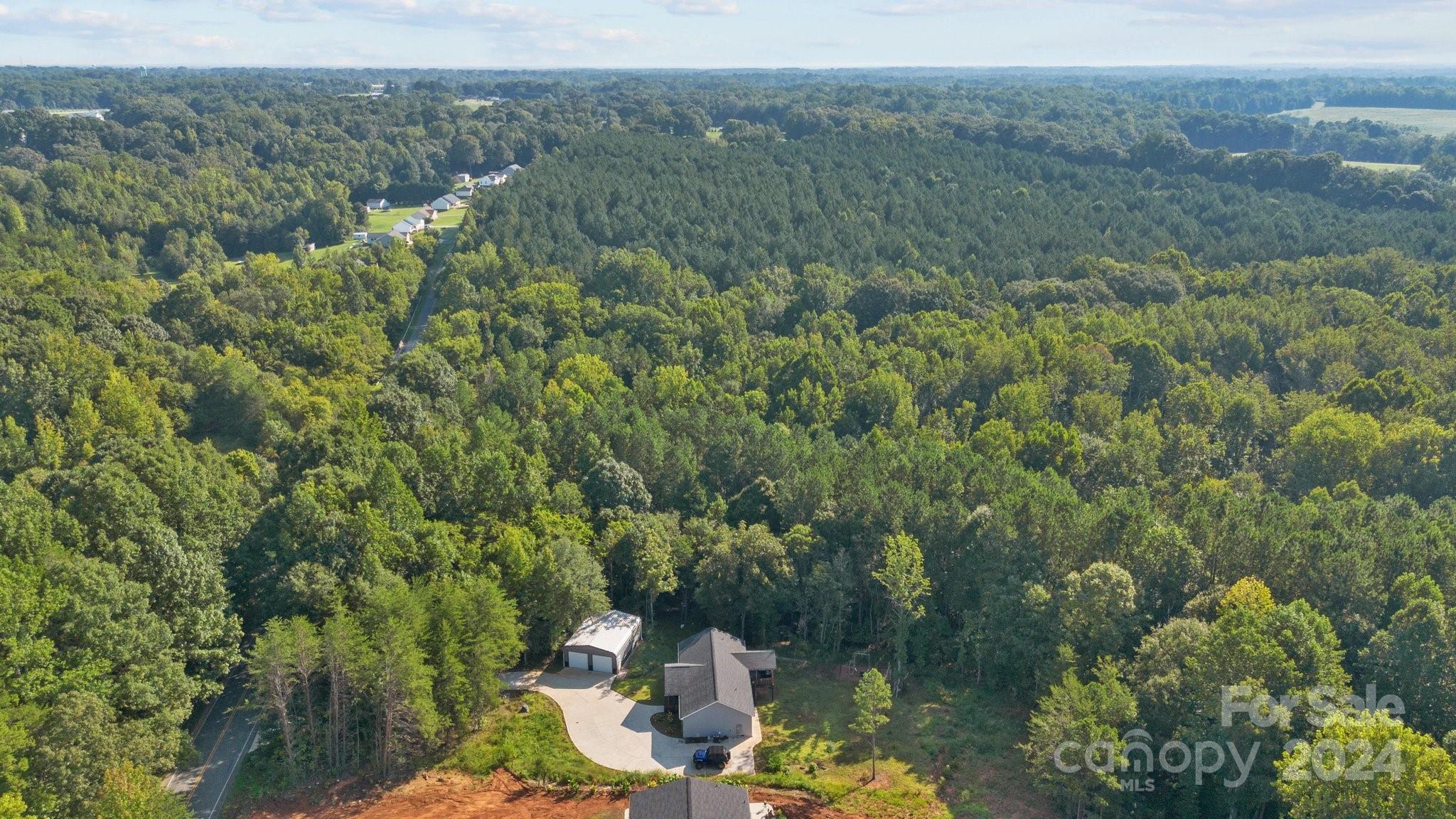 1455 Lawrence Road Clover, SC 29710 - Photo 31 of 35 an aerial view of a forest with houses