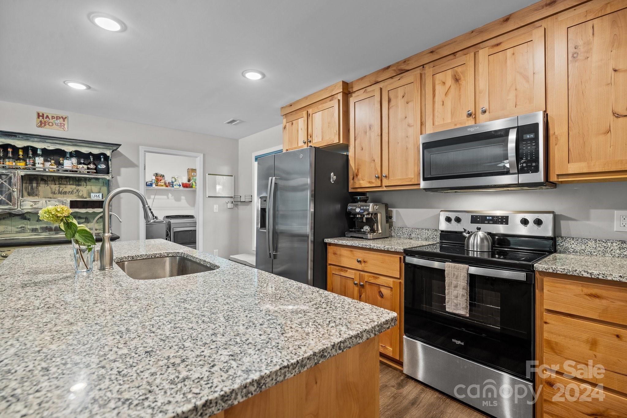 1455 Lawrence Road Clover, SC 29710 - Photo 7 of 35 a kitchen with stainless steel appliances granite countertop a sink stove microwave and refrigerator
