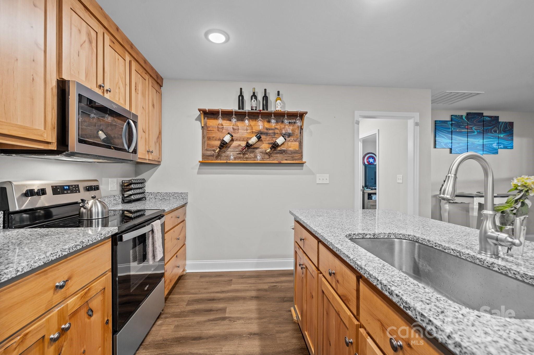 1455 Lawrence Road Clover, SC 29710 - Photo 8 of 35 a kitchen with stainless steel appliances granite countertop a sink stove and microwave