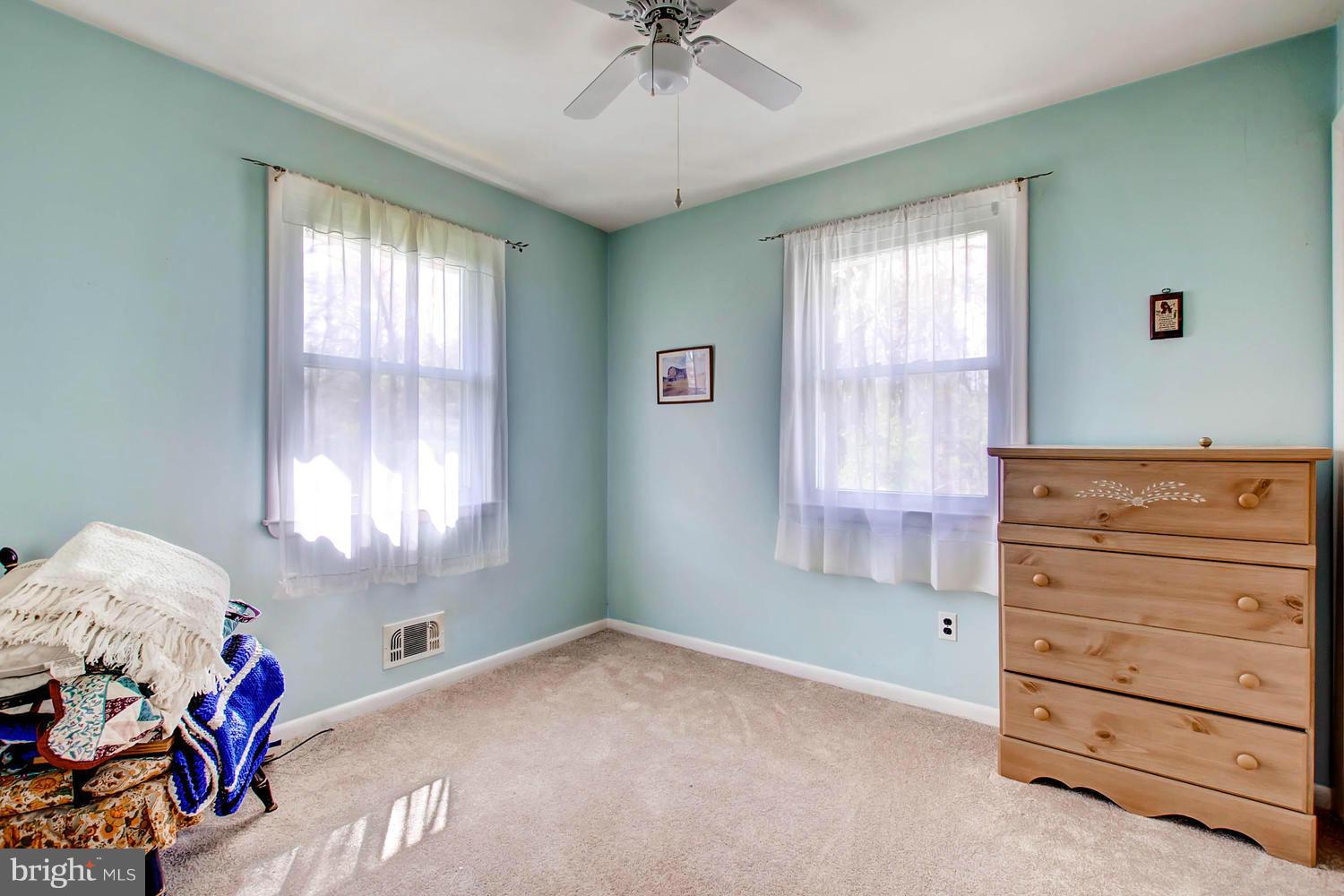 407 Homewood Road Linthicum, MD 21090 - Photo 14 of 23 a bedroom with a dresser and a window