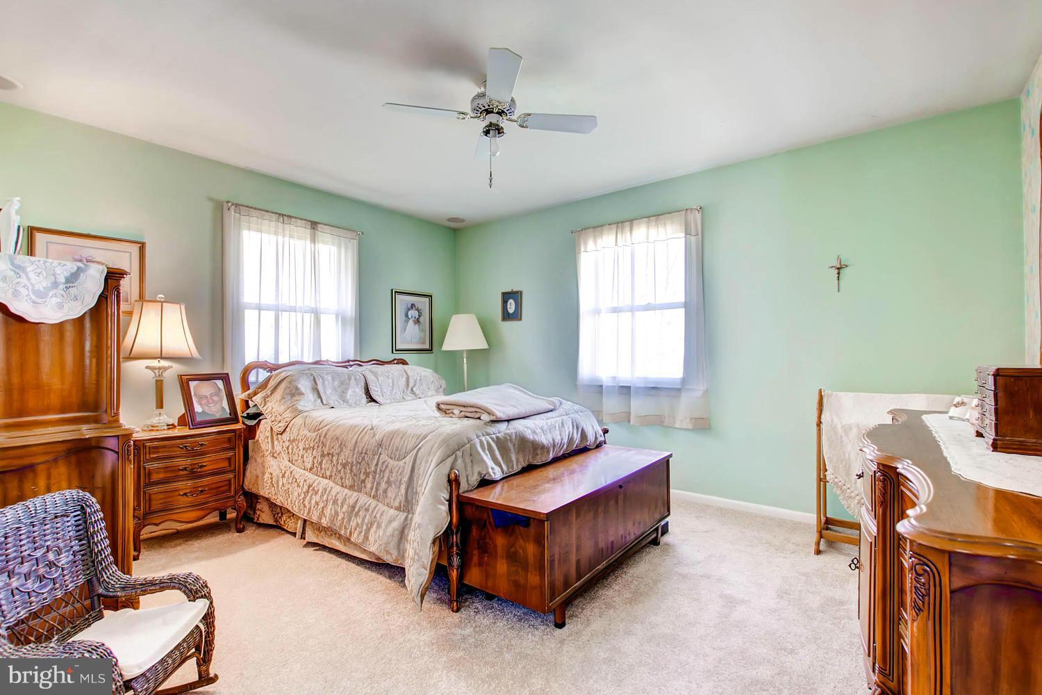 407 Homewood Road Linthicum, MD 21090 - Photo 10 of 23 a spacious bedroom with a bed and a chandelier