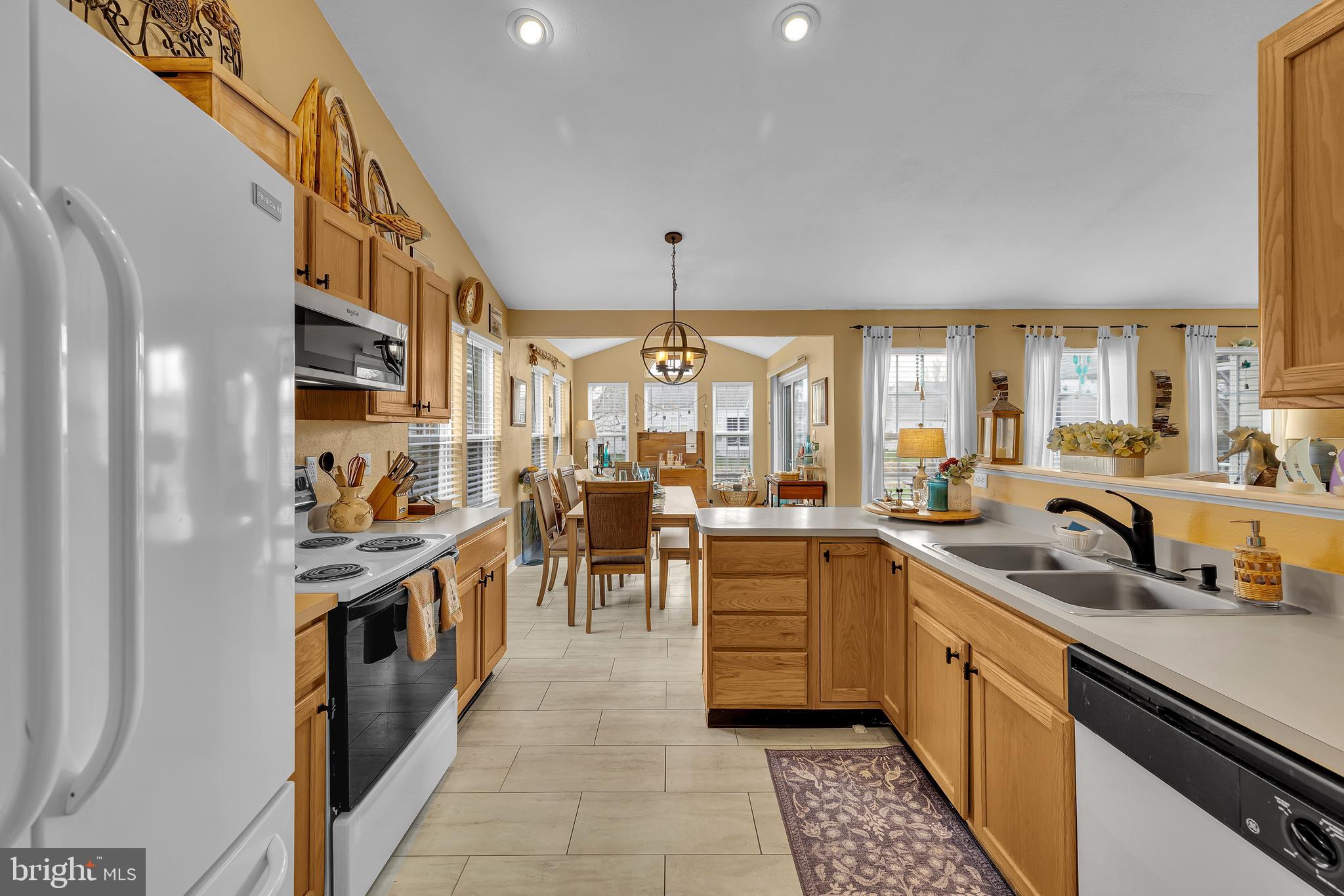 33525 Westhampton Lane Ocean View, DE 19970 - Photo 11 of 49 a kitchen that has a lot of white cabinets and stainless steel appliances