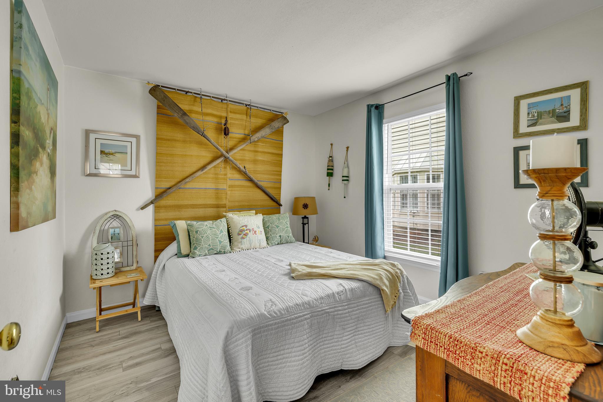 33525 Westhampton Lane Ocean View, DE 19970 - Photo 13 of 49 a bedroom with a bed and a table