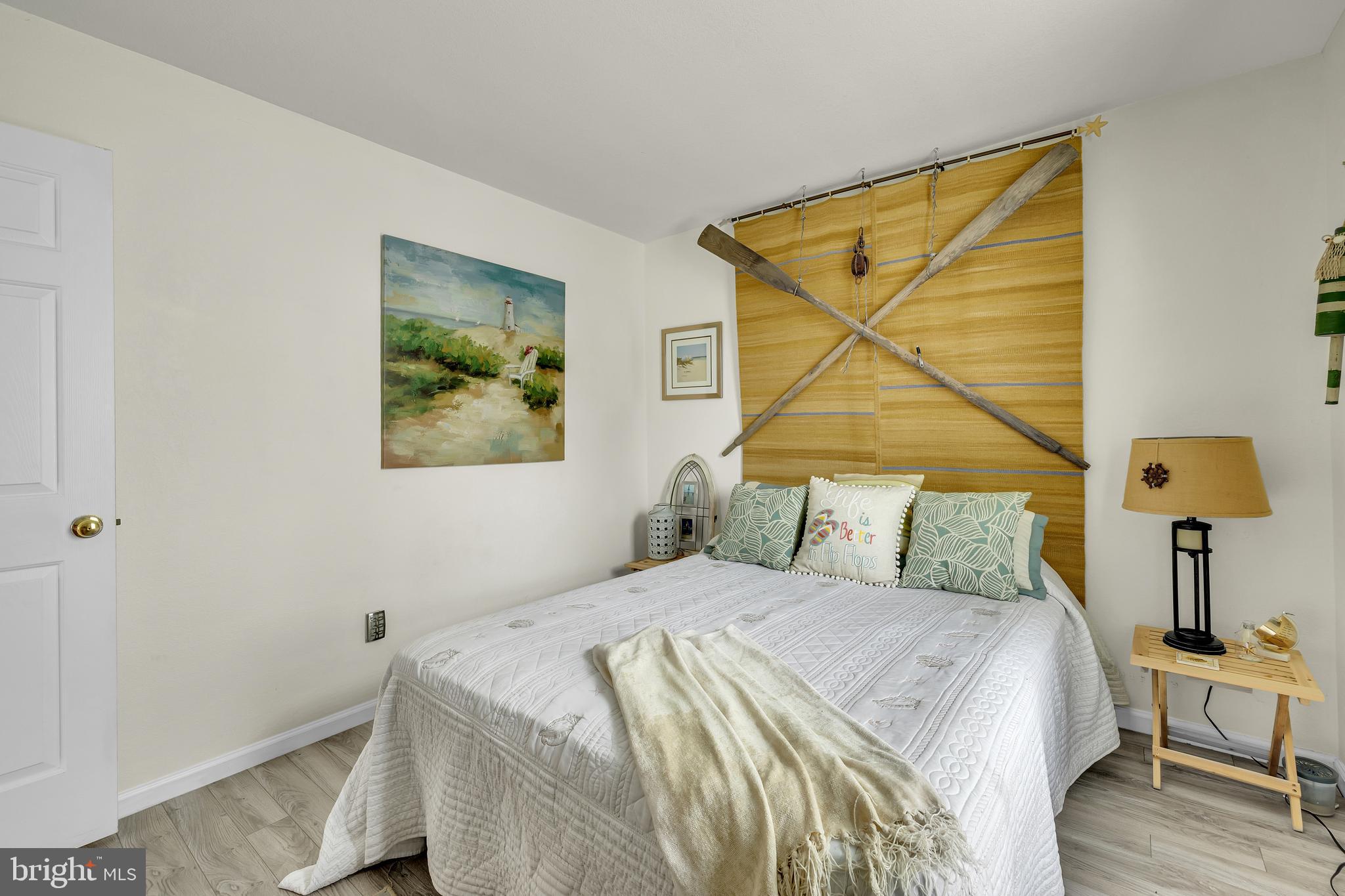 33525 Westhampton Lane Ocean View, DE 19970 - Photo 14 of 49 a bedroom with a bed and a painting on the wall