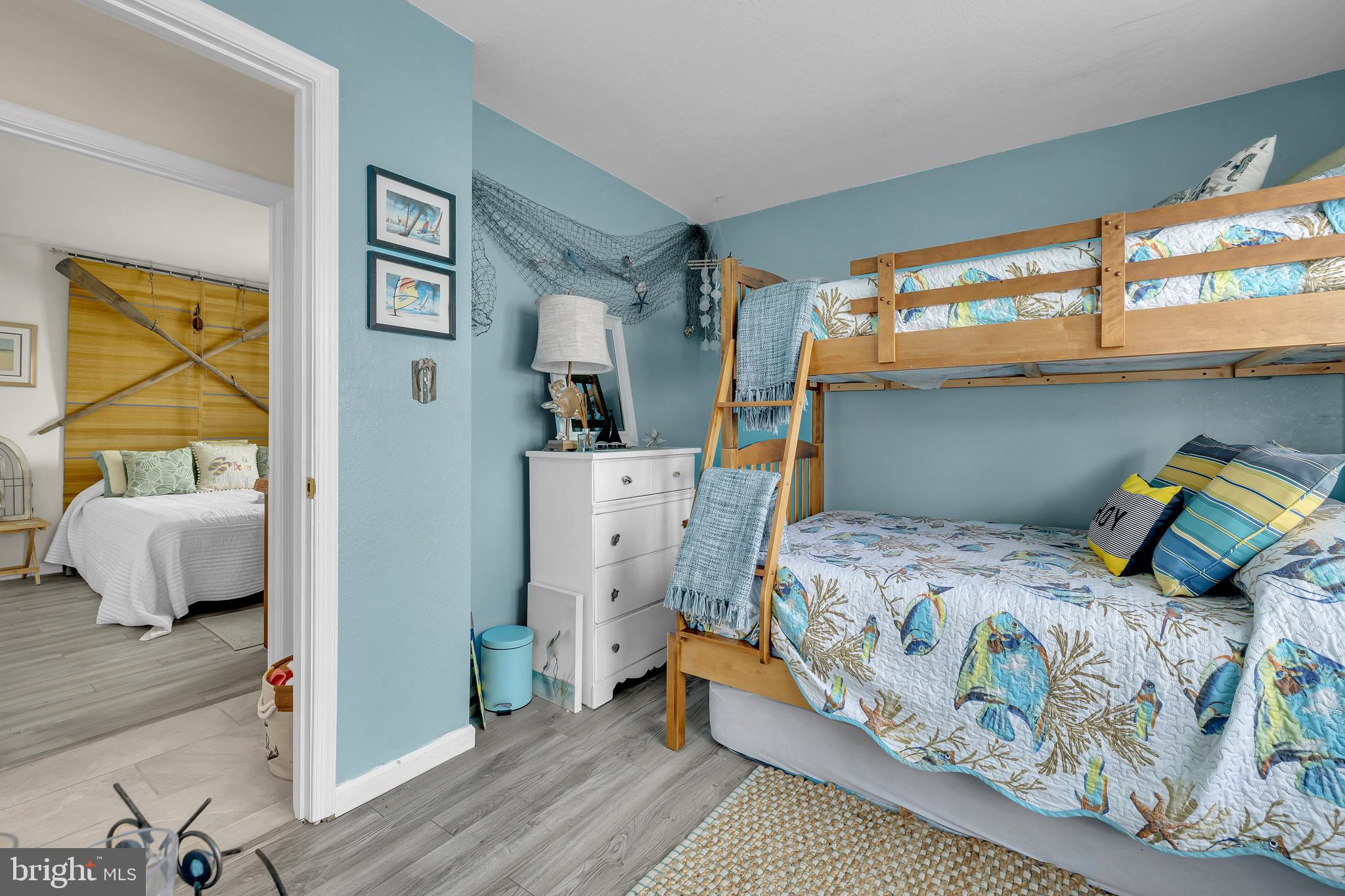 33525 Westhampton Lane Ocean View, DE 19970 - Photo 16 of 49 a bedroom with a bed and wooden floor