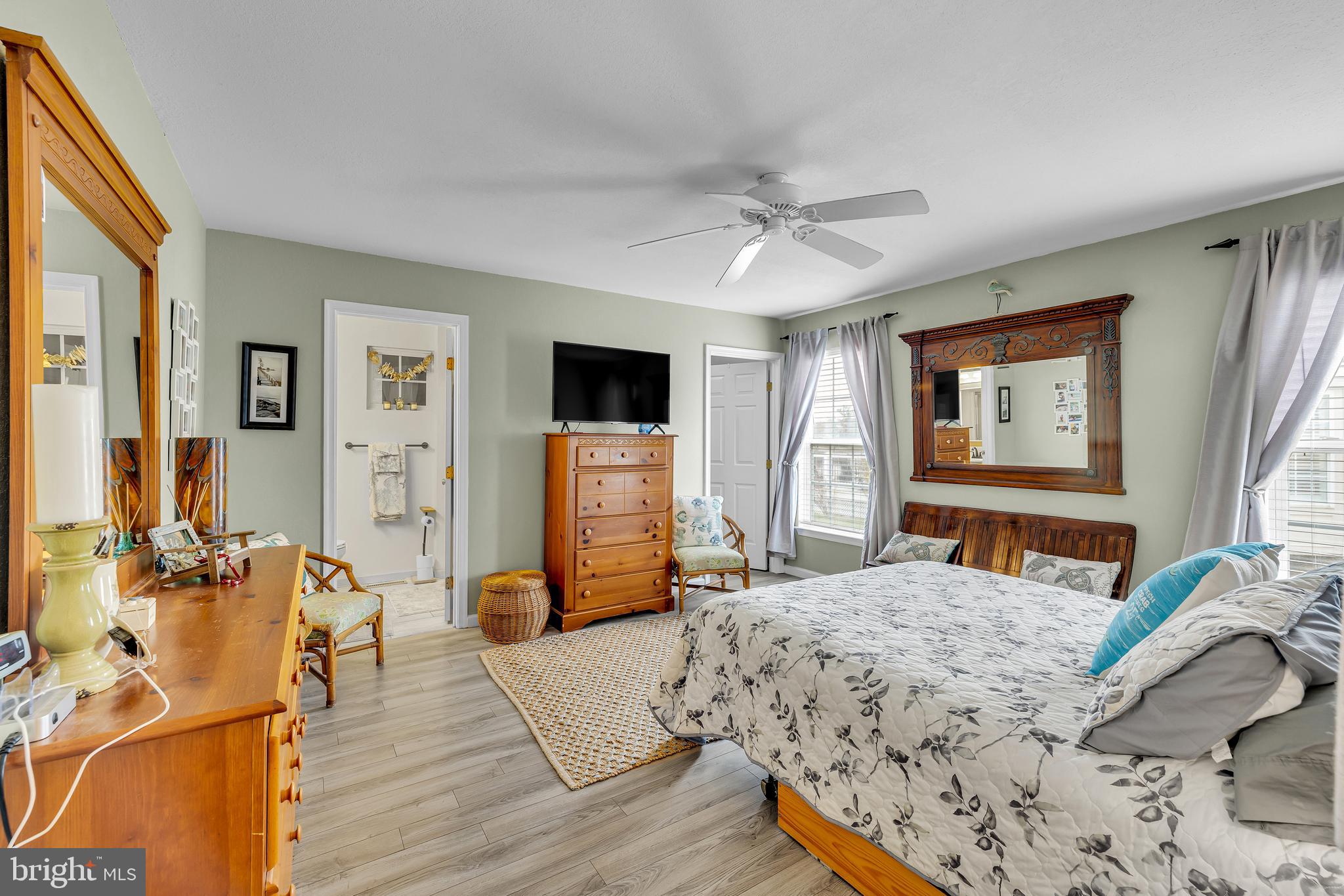 33525 Westhampton Lane Ocean View, DE 19970 - Photo 18 of 49 a bedroom with a bed and wooden floor