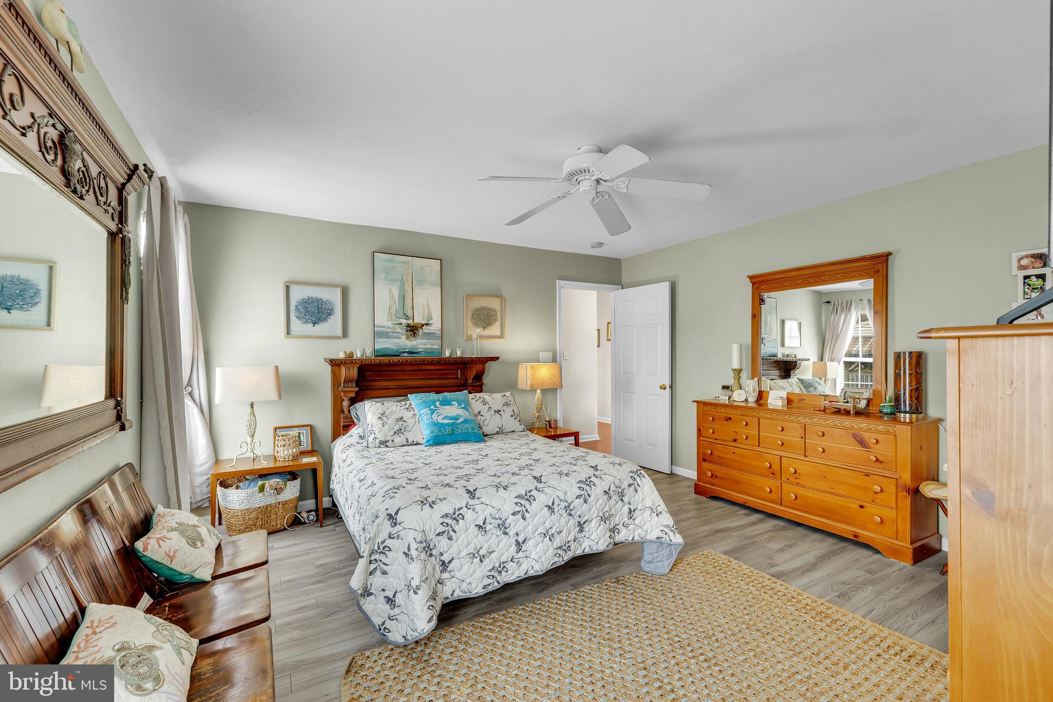 33525 Westhampton Lane Ocean View, DE 19970 - Photo 20 of 49 a bedroom with a bed and wooden floor