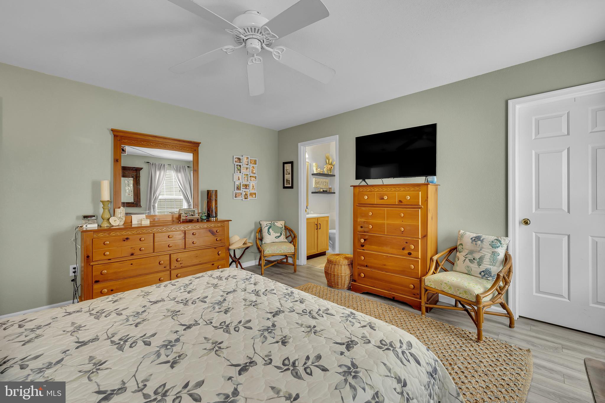 33525 Westhampton Lane Ocean View, DE 19970 - Photo 21 of 49 a bedroom with a bed and wooden floor