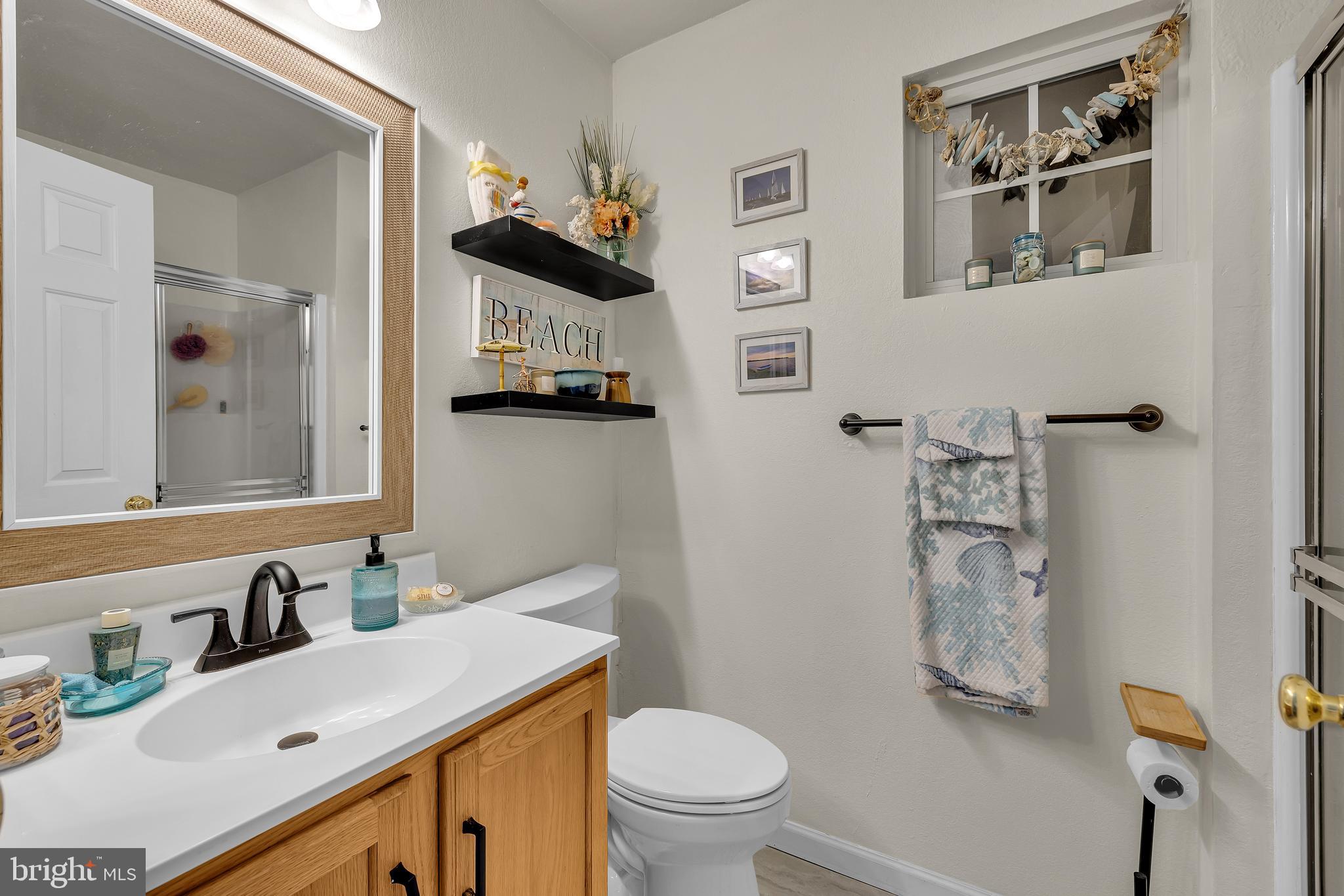 33525 Westhampton Lane Ocean View, DE 19970 - Photo 22 of 49 a bathroom with a sink vanity mirror and toilet