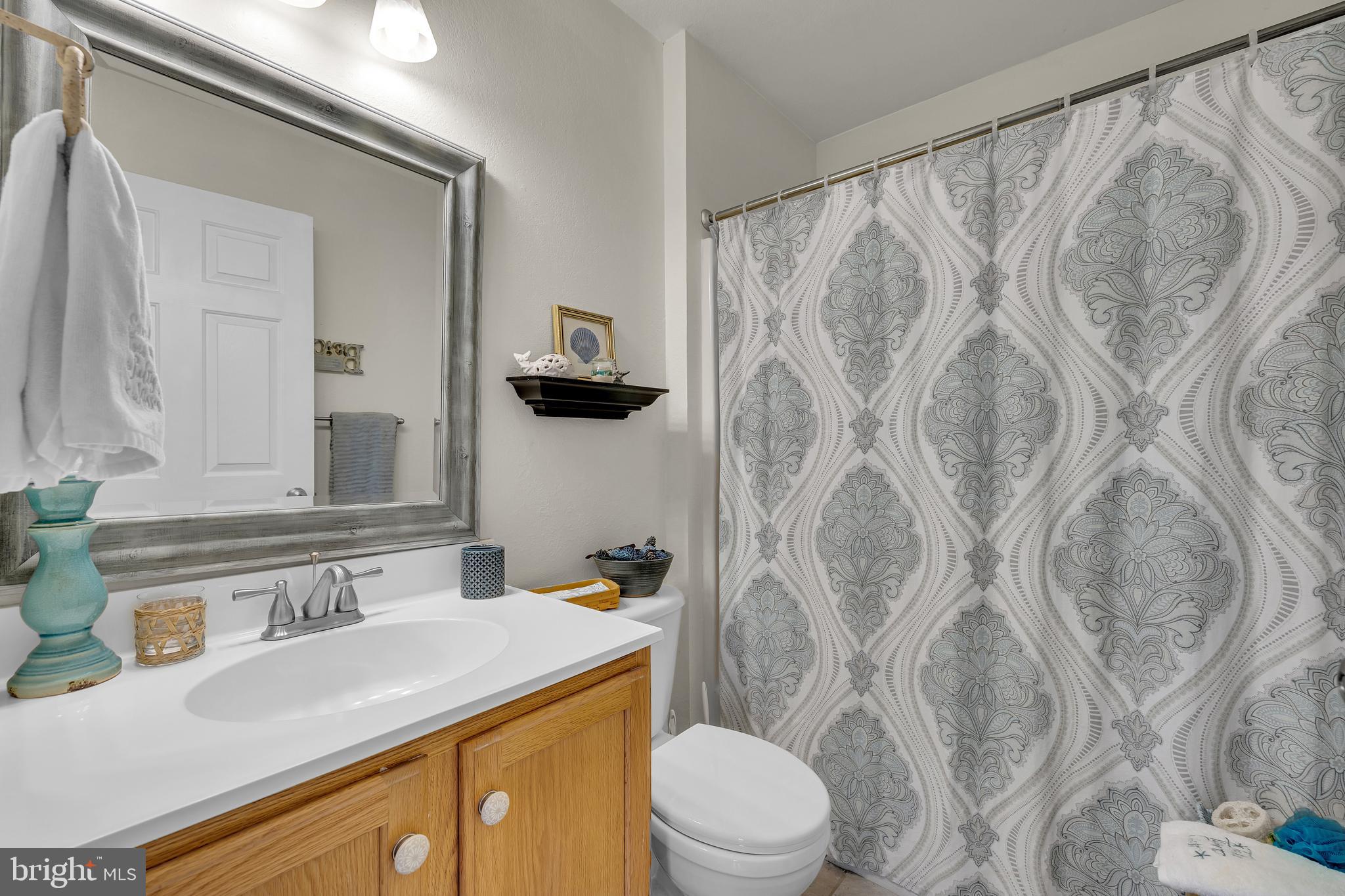 33525 Westhampton Lane Ocean View, DE 19970 - Photo 24 of 49 a bathroom with a sink a toilet and a mirror