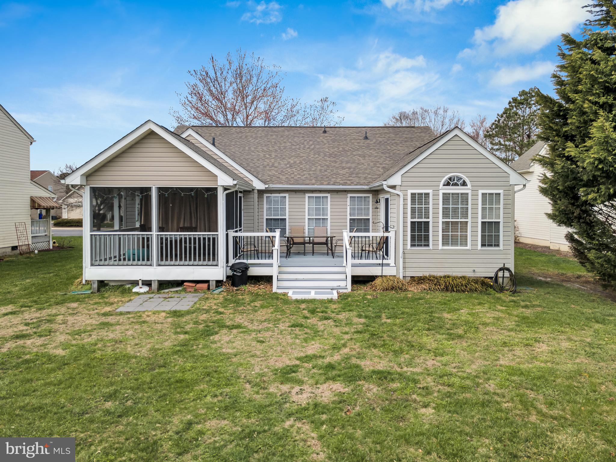 33525 Westhampton Lane Ocean View, DE 19970 - Photo 32 of 49 a view of a house with a large window and a yard with a large trees