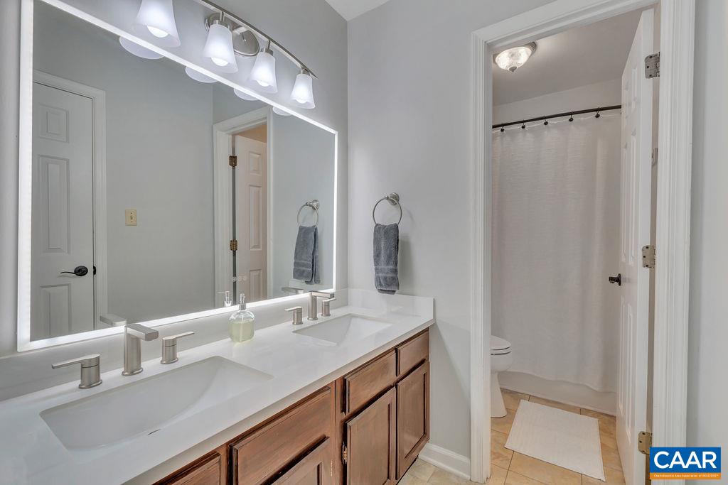 1436 Minor Ridge Court Charlottesville, VA 22901 - Photo 32 of 59 a bathroom with a sink double vanity and a mirror