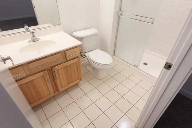 a white toilet sitting next to a bathroom sink