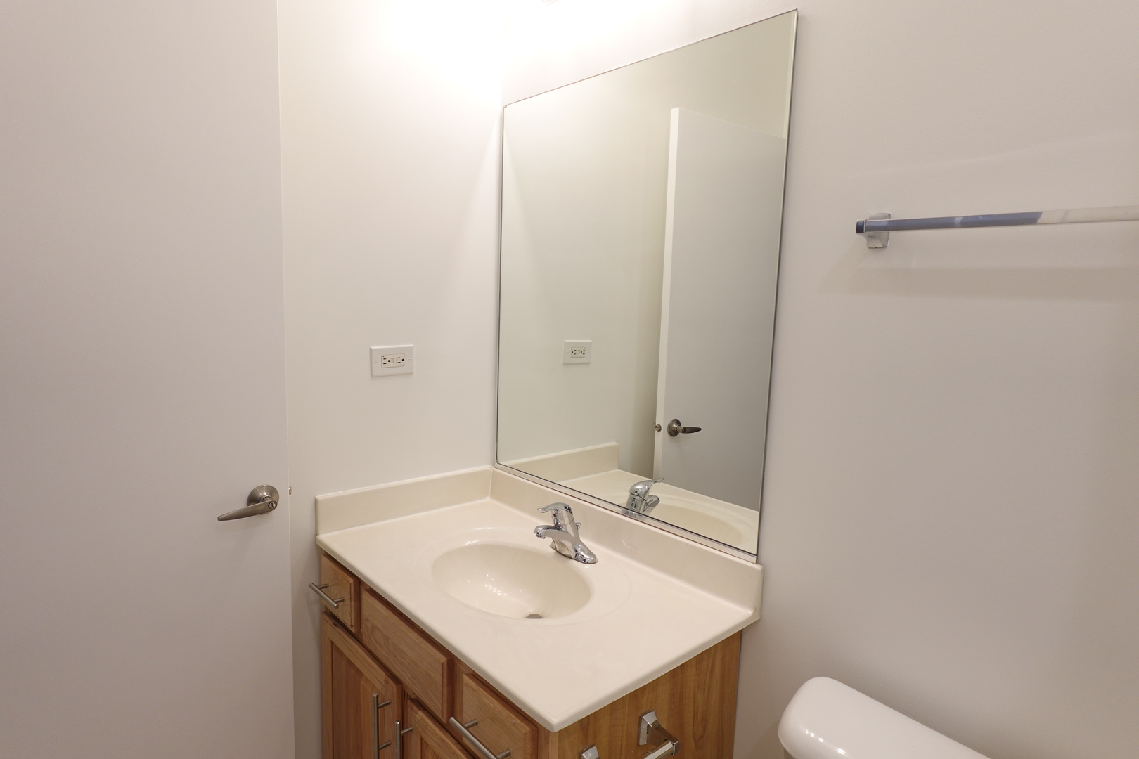 3963 West Belmont Avenue, Unit 219 Chicago, IL 60618 - Photo 16 of 28 a bathroom with a sink and mirror with toilet