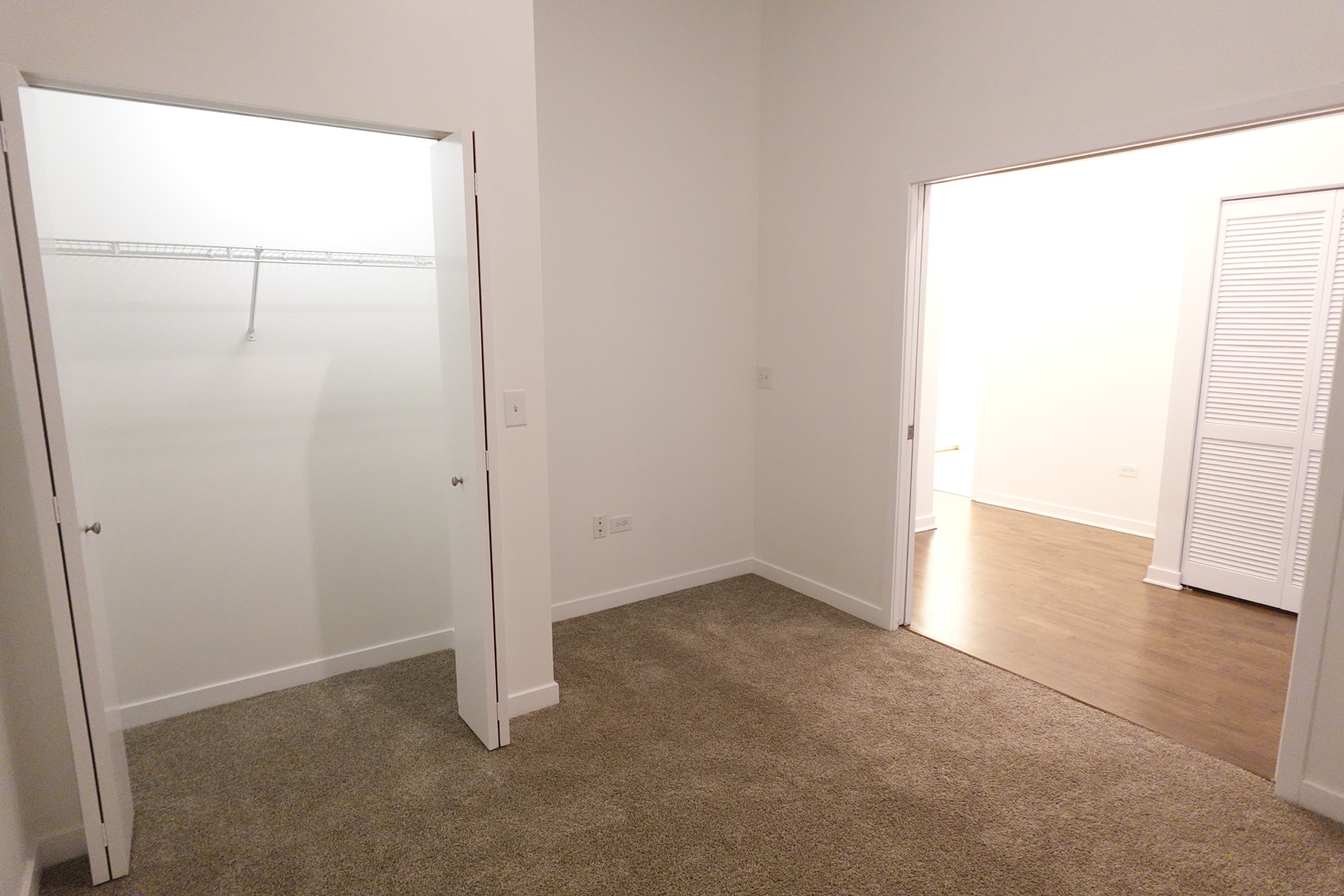 3963 West Belmont Avenue, Unit 219 Chicago, IL 60618 - Photo 20 of 28 an empty room with a door