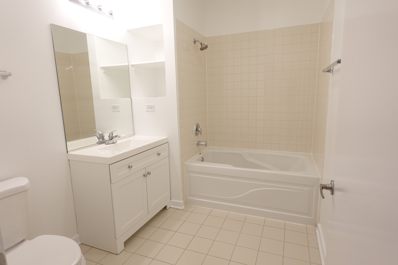 3963 West Belmont Avenue, Unit 219 Chicago, IL 60618 - Photo 22 of 28 a bathroom with a granite countertop sink toilet and shower