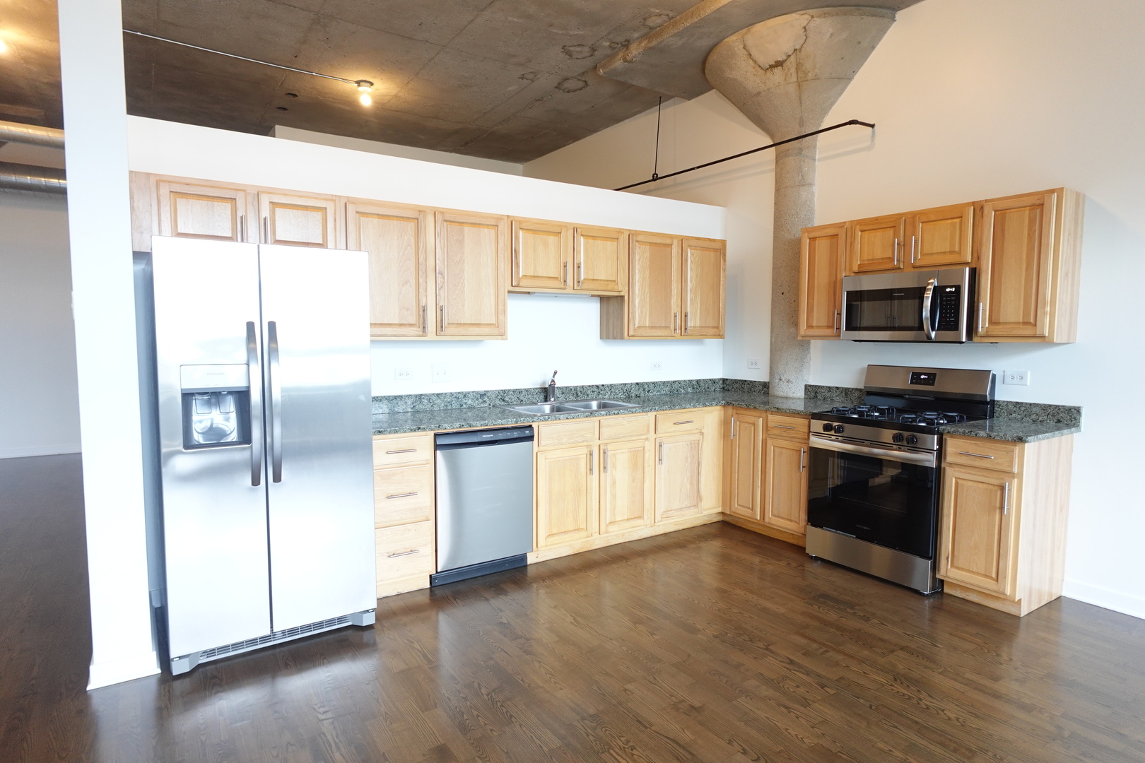 3963 West Belmont Avenue, Unit 219 Chicago, IL 60618 - Photo 10 of 28 a kitchen with stainless steel appliances granite countertop a stove top oven a sink and a refrigerator