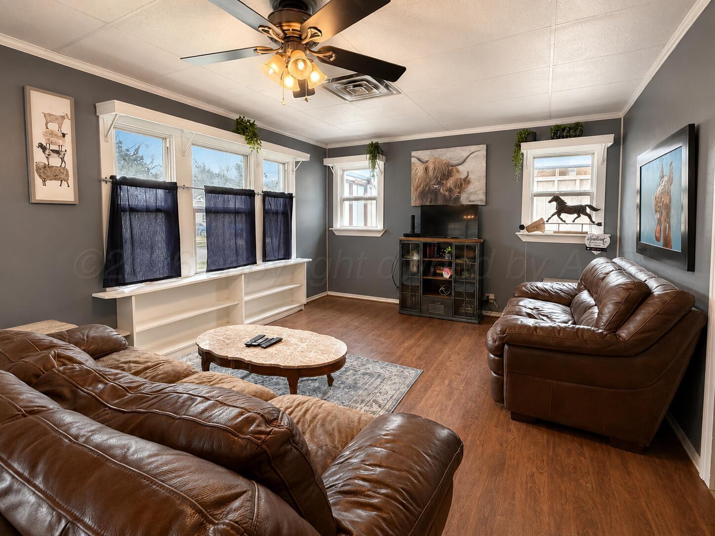 606 South Prospect Street Amarillo, TX 79106 - Photo 9 of 22 a living room with furniture and a flat screen tv with wooden floor