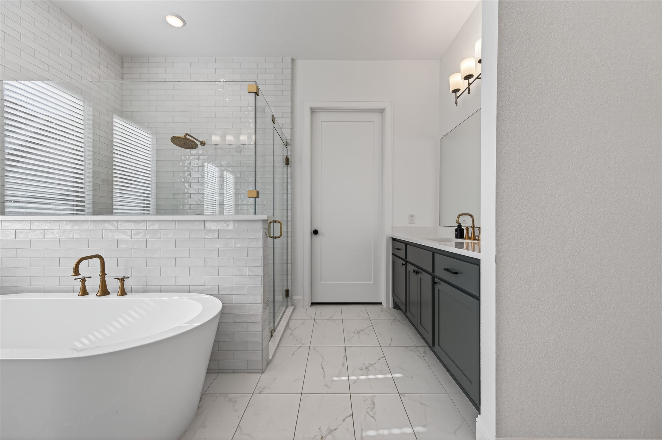 175 Shoveler Duck Way Magnolia, TX 77354 - Photo 25 of 48 a spacious bathroom with a double vanity sink a mirror and a bathtub