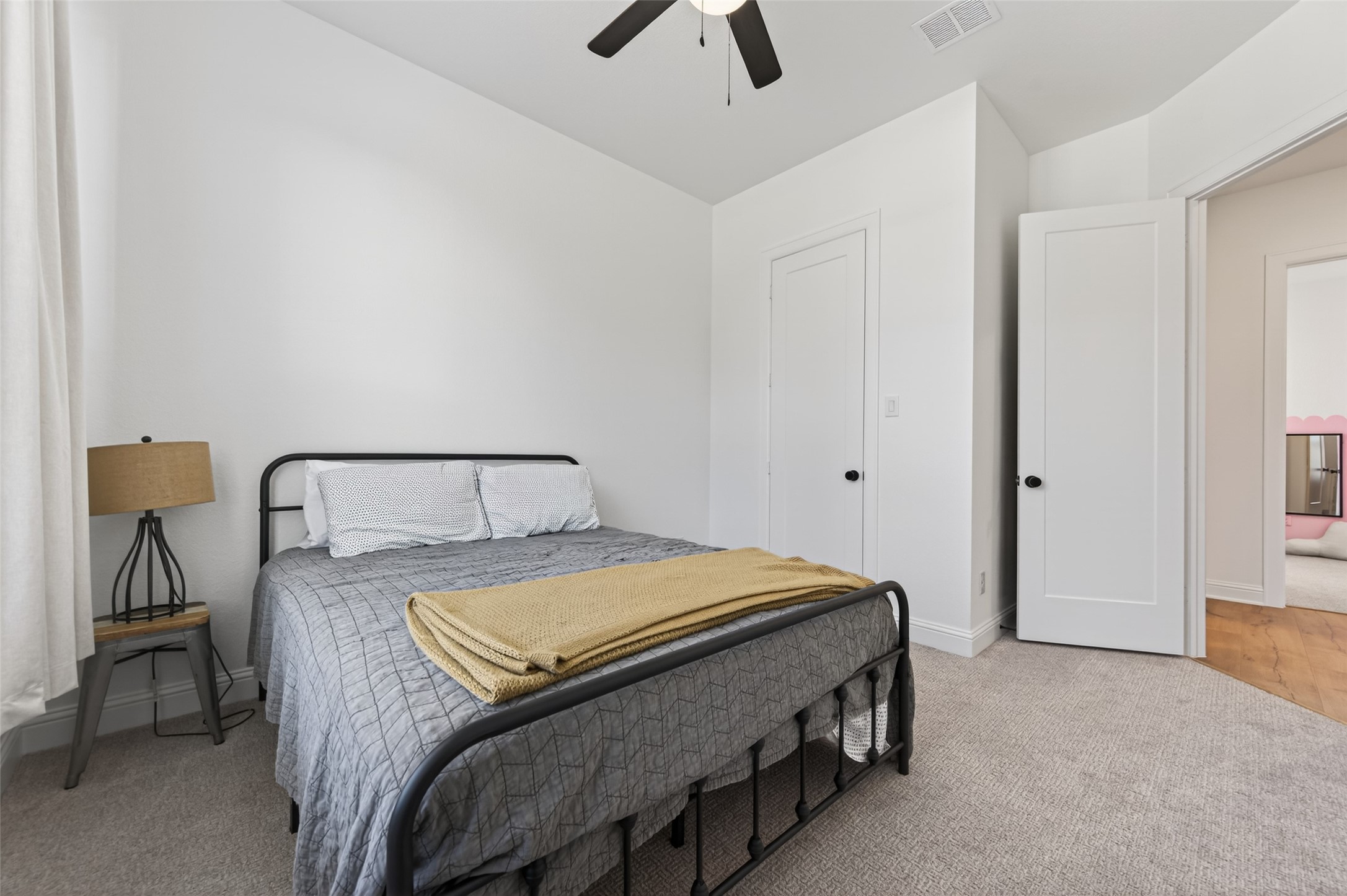 175 Shoveler Duck Way Magnolia, TX 77354 - Photo 37 of 48 a bedroom with a bed and a chandelier