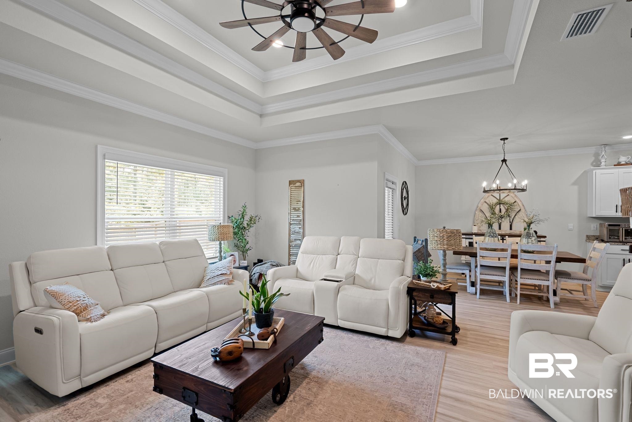 13966 Antler Hl Road Daphne, AL 36527 - Photo 13 of 44 Living area featuring a multi-tiered tray ceiling with a ceiling fan