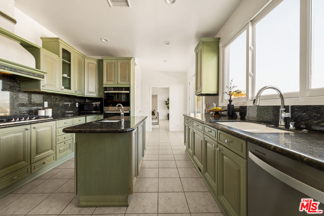 8527 Hedges Way Los Angeles, CA 90069 - Photo 14 of 25 a kitchen with stainless steel appliances granite countertop a sink and cabinets