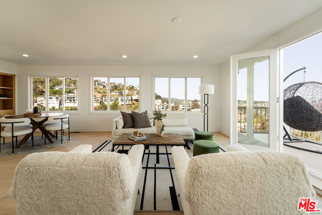 8527 Hedges Way Los Angeles, CA 90069 - Photo 18 of 25 a living room with furniture a large window and a fireplace