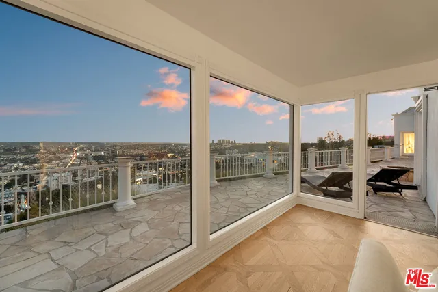 a view of a floor to ceiling window and an outdoor kitchen