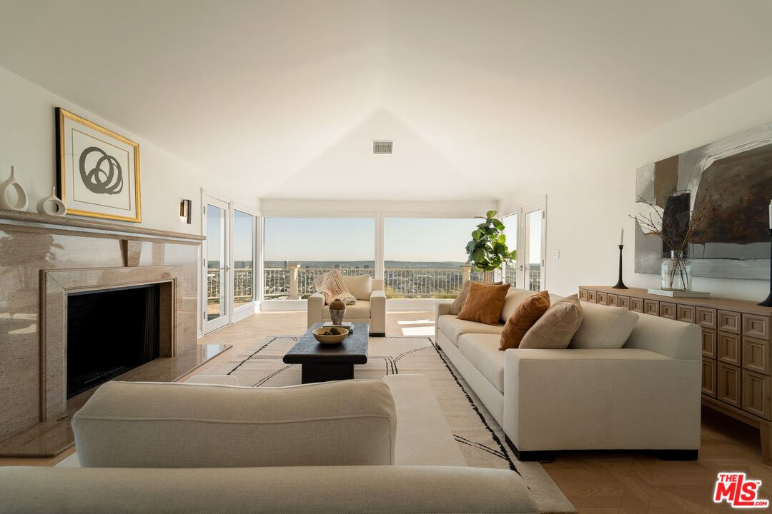 8527 Hedges Way Los Angeles, CA 90069 - Photo 4 of 25 a living room with furniture a fireplace and a flat screen tv